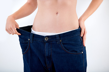 Image showing Weight, loss and abdomen of woman in jeans with comparison of size on white background in studio. Healthy, body and person with transformation or change from diet and show results in denim pants