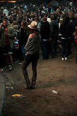 Image showing Back, music festival and a woman in the crowd of a concert at night for an event, show or performance. Party, carnival and a person in the audience of a social gathering for live entertainment