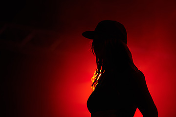 Image showing Woman, red light and silhouette at party concert or festival night, stage event or dark. Female person, strobe and glow for artistic creative shadow for dance rave, entertainment or mockup background