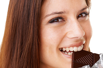 Image showing Smile, eating and portrait of woman with chocolate in a studio for dessert with positive attitude. Happy, face and closeup of young female person enjoying candy for snack isolated by white background