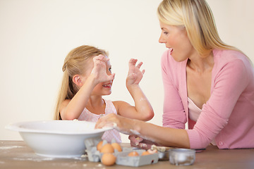 Image showing Kitchen, baking and happy family playing, love and home mother and daughter bond, have fun and prepare recipe ingredients. Smile, goofy mama and silly kid learning cooking together with playful mom