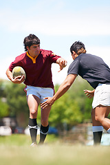Image showing Rugby player, game and tackle on a field during competitive sport match outdoors. Teamwork, training and playing professional athletic exercise in uniform to avoid person outdoor for practice