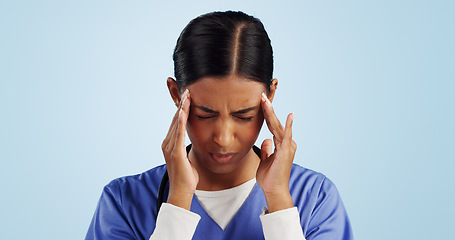 Image showing Doctor, studio or woman with headache, emergency or fatigue in medical healthcare crisis or head pain. Depression, face or tired nurse with burnout, migraine or stress isolated on blue background