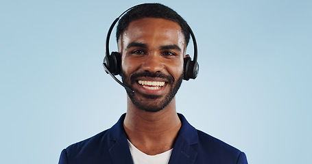 Image showing Happy man, portrait and headphones for call center or telemarketing against a blue studio background. Face of friendly male person, consultant or agent smile with mic in online advice on mockup space