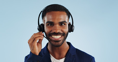 Image showing Happy businessman, portrait and headphones for call center or telemarketing against a blue studio background. Face of male person, consultant or agent smile with mic for online advice on mockup space