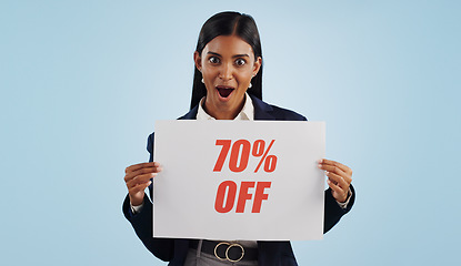 Image showing Happy woman, portrait and sale sign for advertising, discount or deal against a blue studio background. Female person with billboard or poster for marketing, promotion or special on mockup space