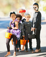 Image showing Children, halloween or trick and treat portrait outdoor in neighborhood for fun and dress up. A group of young kids together for happiness, celebrate holiday and diversity with candy or sweets