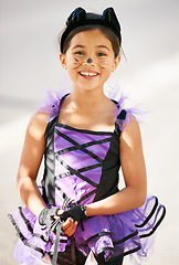 Image showing Portrait, halloween and a girl in a cat costume for a trick or treat tradition in her neighborhood. Kids, smile and fantasy with a young child on the street for holiday celebration un autumn or fall