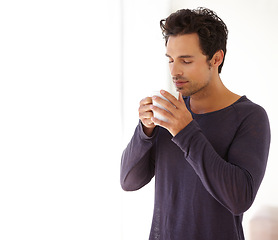 Image showing Man, coffee and face with aroma or smile in the morning for relax, peace and satisfaction at home. Person, happy and thoughtful with espresso, beverage or hot chocolate for smell, wellness or ideas