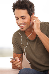 Image showing Man, player or earphones or smile with music, podcast or radio streaming for break in living room of home. Person, face or listening and technology on couch in lounge for sound, song or audio track