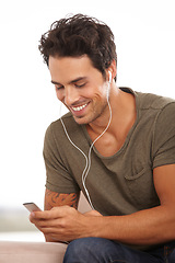 Image showing Man, player and earphones or happy with music, podcast or radio streaming for break in living room of home. Person, face or listening and technology on couch in lounge for sound, song and audio track