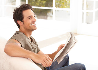 Image showing Man, face and happy with newspaper on sofa for relax, morning break and information in living room. Person, excited and smile for article, story and news on couch of apartment for reading or peace