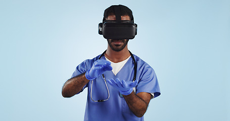 Image showing Doctor, man and virtual reality glasses for surgery, healthcare innovation and surgeon on a blue studio background. Person, medical and professional with VR eyewear, future and tech with digital app