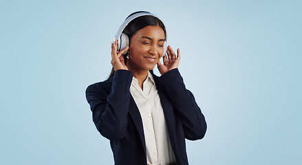 Image showing Headphones, studio or happy businesswoman listening to music isolated on blue background. Dance, smile or calm female person streaming a radio song, sound or audio on online subscription to relax