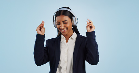 Image showing Headphones, dancing or happy businesswoman in studio for music isolated on blue background. Energy, smile or calm female person streaming a radio song, sound or audio on online subscription to relax