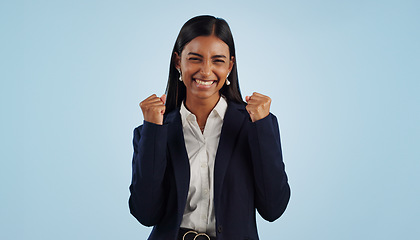 Image showing Winner, excited or happy woman in celebration for a business deal isolated on blue background. Wow, goals or proud Indian lady with smile, victory success or reward in entrepreneurship or studio