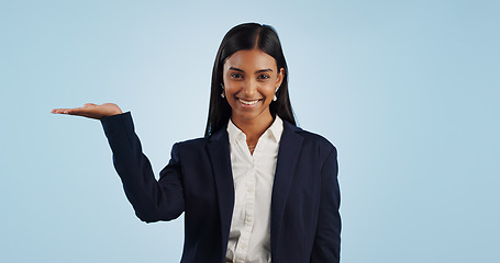 Image showing Portrait of businesswoman, studio or palm for investment deal, financial offer or product mockup space. Hand, smile or happy Indian corporate lady on blue background marketing, advertising or finance