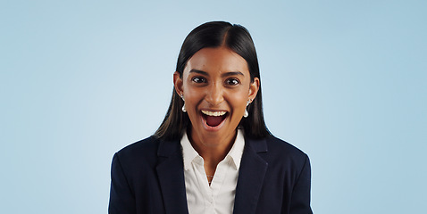 Image showing Surprise, excited or portrait of woman in celebration for a business deal on blue background. Wow, goals or shocked Indian lady with smile, victory success or reward in entrepreneurship or studio