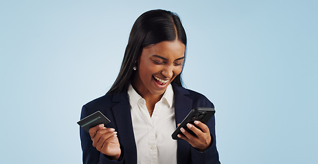 Image showing Excited business woman, phone and credit card for payment or online shopping against a blue studio background. Happy female person smile with mobile smartphone for banking or transaction on mockup