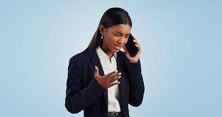 Image showing Business, phone call and woman with stress, angry and employee isolated on a blue studio background. Mockup space, person and entrepreneur with a smartphone, connection and frustrated with emotions