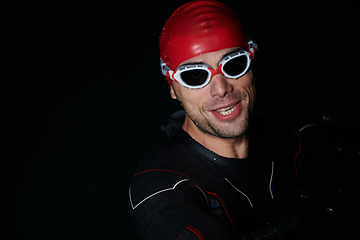 Image showing A triathlete finds serene rejuvenation in a lake, basking in the tranquility of the water after an intense training session