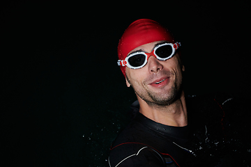 Image showing A triathlete finds serene rejuvenation in a lake, basking in the tranquility of the water after an intense training session