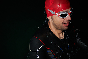 Image showing A triathlete finds serene rejuvenation in a lake, basking in the tranquility of the water after an intense training session