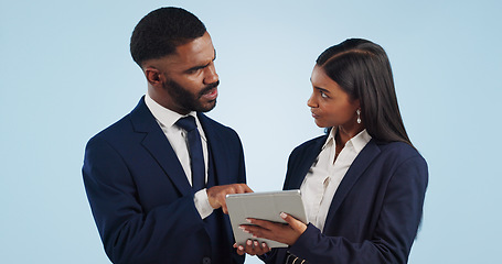 Image showing Collaboration, tablet and a professional business team in studio on a blue background for problem solving. Technology, data or feedback with a corporate man and woman talking about information