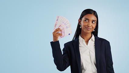 Image showing Happy business woman, thinking and money fan in financial freedom against a blue studio background. Female person or employee in thought or wonder with cash, savings or investment on mockup space