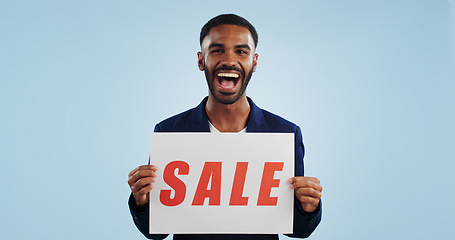 Image showing Excited man, portrait and sale sign for advertising, deal or discount against a blue studio background. Happy male person showing billboard or poster for marketing, promotion or special on mockup