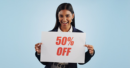Image showing Happy woman, portrait and sign for advertising discount, deal or half price against a blue studio background. Female person with billboard or poster in marketing, promotion or special on mockup space