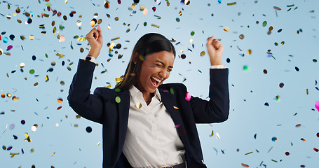 Image showing Happy business woman, confetti and celebration for winning or promotion against a blue studio background. Excited female person or employee smile in freedom for victory, achievement or party event