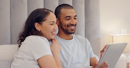 Image showing Tablet, smile and young couple in bed watching a video on social media or the internet together at home. Happy, digital technology and man and woman relaxing and bonding in bedroom at modern house.