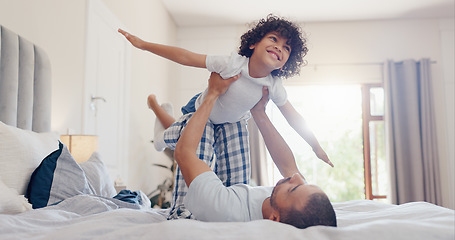 Image showing Happy father, child and playing on bed for bonding, holiday or fun weekend together in morning at home. Dad lying, lifting or kid flying in bedroom for love, care or support in embrace at house