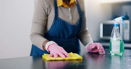 Image showing Woman, hands and cleaning table in kitchen for housekeeping, hygiene or sanitary surface at home. Closeup of female person, maid or cleaner wiping furniture for disinfection, germ or bacteria removal