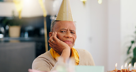 Image showing Sad, birthday and portrait of senior woman with depression, grief and lonely in her home. Cake, face and elderly African person alone at a party with disappointment, frustrated or annoyed in a house