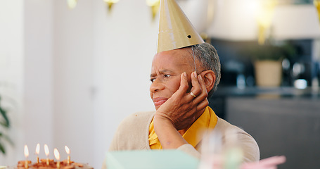 Image showing Thinking, birthday and sad senior woman with depression, grief and lonely in her home. Cake, face and elderly African person alone at a party with disappointment, frustrated or annoyed in a house