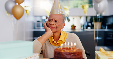 Image showing Sad, birthday and senior woman thinking with depression, grief and lonely in her home. Cake, face and elderly African person alone at a party with disappointment, frustrated or annoyed in a house