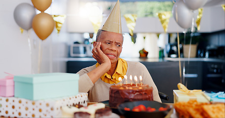 Image showing Birthday, thinking and sad senior woman with depression, grief and lonely in her home. Cake, face and elderly African person alone at a party with disappointment, frustrated or annoyed in a house
