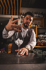 Image showing Bartender stirring ice cubes