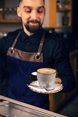 Image showing Waiter serving hot coffee