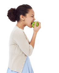 Image showing Woman, eating apple and healthy food choice for detox, dental health and wellness on a white background. Profile of a young person biting a green fruit for nutrition, strong teeth or vegan in studio