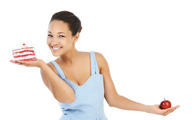 Image showing Woman portrait, apple and cake for healthy food choice, balance and diet decision in studio. Happy, young person or model with red fruit versus cream dessert for detox or vegan on a white background