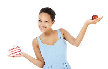 Image showing Happy woman, apple and cake for healthy food choice, balance and diet decision in studio. Portrait of young person or model and red fruit versus cream dessert in palm for health on a white background