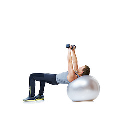 Image showing Fitness, exercise ball or man with dumbbell in studio for abs, core or balance challenge on white background. Workout, weightlifting or male bodybuilder with inflatable for wellness or sports routine