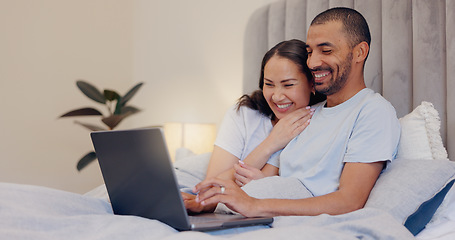 Image showing Laptop, happy and young couple in bed watching movie, film or show together at home. Smile, technology and man and woman relaxing in bedroom streaming a video on computer for bonding at modern house.