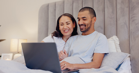 Image showing Laptop, smile and young couple in bed watching movie, film or show together at home. Happy, technology and man and woman relaxing in bedroom streaming a video on computer for bonding at modern house.