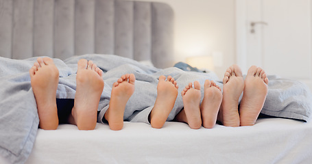 Image showing Sleeping feet, relax and family in bed with love, bond or security at home together. Barefoot, children or parents in a bedroom with comfort, trust and care, protection or nap with safety in a house
