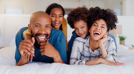 Image showing Smile, portrait and children with parents in bed of modern home for bonding together with teddy bear. Happy, fun and young interracial man and woman relaxing with kids in bedroom of family house.