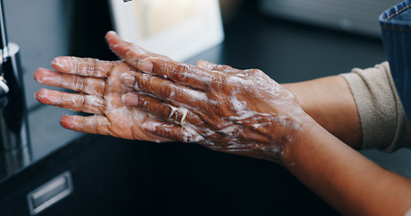 Image showing Person, soap and washing hands for hygiene, germ or bacteria removal by tap or sink at home. Closeup of palm in skincare, protection or soapy skin for cleaning, dirt or disinfection by basin at house